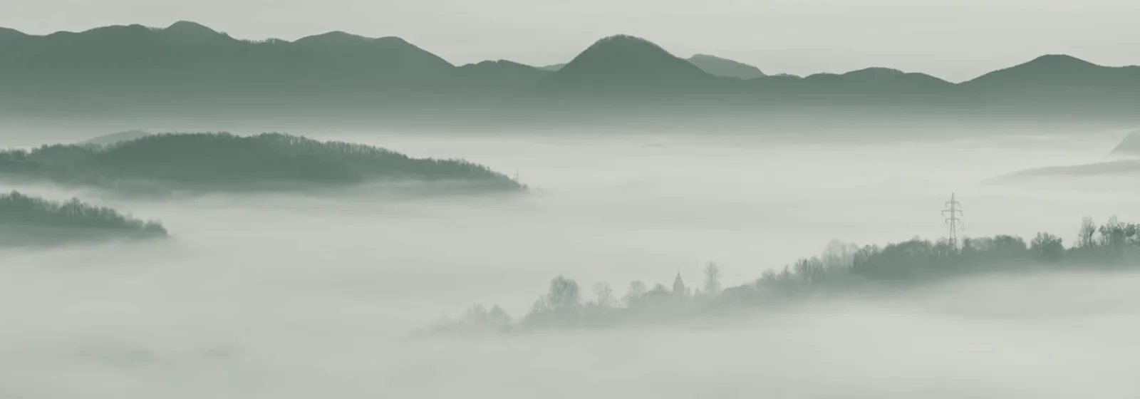 Layered mountain ridges receding into morning mist